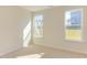 Well-lit bedroom with neutral carpeting and two windows at 128 Baird Cv Ln, Angier, NC 27501