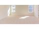 Well-lit bedroom with neutral carpeting and two windows at 128 Baird Cv Ln, Angier, NC 27501
