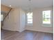 Bright dining room featuring hardwood floors, light walls, and large windows at 128 Baird Cv Ln, Angier, NC 27501