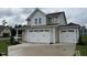 Two-story house with beige siding, white trim, and a three-car garage at 128 Baird Cv Ln, Angier, NC 27501