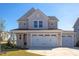 Two-story house with beige siding, white trim, and a three-car garage at 128 Baird Cv Ln, Angier, NC 27501