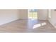 Spacious Gathering room with hardwood floors and sliding glass doors leading to patio at 128 Baird Cv Ln, Angier, NC 27501