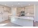 Modern kitchen with an island, stainless steel appliances, and light cabinets at 128 Baird Cv Ln, Angier, NC 27501
