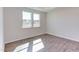Bright bedroom with two windows and wood-look flooring at 133 Barn Door Dr, Lillington, NC 27546
