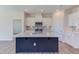 Modern kitchen with large island, stainless steel appliances, and white cabinets at 133 Barn Door Dr, Lillington, NC 27546