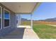 Covered patio with concrete flooring and backyard access at 141 Little Br Dr, Lillington, NC 27546