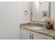 Small powder room with granite countertop and single sink at 1505 Montvale Grant Way, Cary, NC 27519