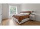 Spacious bedroom with large window, hardwood floors, and ample natural light at 1505 Montvale Grant Way, Cary, NC 27519
