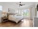 Main bedroom with hardwood floors, large windows, and ceiling fan at 1505 Montvale Grant Way, Cary, NC 27519