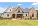 Brick and siding two-story home with a covered porch and manicured lawn at 1505 Montvale Grant Way, Cary, NC 27519