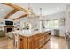Modern kitchen with large island, stainless steel appliances, and wooden cabinets at 1505 Montvale Grant Way, Cary, NC 27519