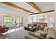 Spacious living room with exposed wooden beams, comfortable seating, and a view of the kitchen at 1505 Montvale Grant Way, Cary, NC 27519
