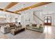 Open concept living room with hardwood floors, exposed beams, and a cozy fireplace at 1505 Montvale Grant Way, Cary, NC 27519
