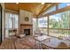 Relaxing screened porch with fireplace, wicker furniture, and wooded views at 1505 Montvale Grant Way, Cary, NC 27519