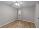 Bright bedroom with wood-look floors, ceiling fan, and a window at 152 Manhattan Ct # 152, Cary, NC 27511