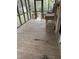 Screened porch with wooden flooring and outdoor sink at 1524 Wedgewood Dr, Graham, NC 27253