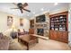 Basement rec room with stone fireplace and built-in shelving at 15508 Possum Track Rd, Raleigh, NC 27614