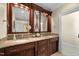 Bathroom with double sinks, granite countertop, and built-in cabinetry at 15508 Possum Track Rd, Raleigh, NC 27614