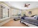Spacious bedroom with large windows, a treadmill and plenty of natural light at 15508 Possum Track Rd, Raleigh, NC 27614