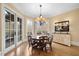 Bright breakfast nook boasts a round table, chandelier, and access to a deck at 15508 Possum Track Rd, Raleigh, NC 27614
