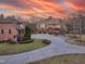 Brick home with circular driveway and sunset view at 15508 Possum Track Rd, Raleigh, NC 27614