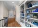 Elegant hallway with built-in shelving and hardwood floors at 15508 Possum Track Rd, Raleigh, NC 27614