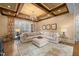 Relaxing living room features coffered ceiling, sectional sofa, hardwood floors at 15508 Possum Track Rd, Raleigh, NC 27614