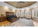 Large main bedroom with high ceiling, king bed, and sitting area at 15508 Possum Track Rd, Raleigh, NC 27614
