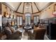 Music room with leather seating, guitars on the wall, and a cozy atmosphere at 15508 Possum Track Rd, Raleigh, NC 27614