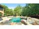 Inviting freeform pool with a spa and flagstone patio at 15508 Possum Track Rd, Raleigh, NC 27614