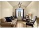 Charming sitting room with hardwood floors, arched window, and comfortable seating at 15508 Possum Track Rd, Raleigh, NC 27614