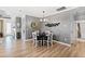 Bright dining area with four chairs and a round table, hardwood floors and decorative wall art at 1626 Plover Cir, Fuquay Varina, NC 27526