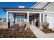Inviting front porch with rocking chairs, brick columns, and landscaping at 1626 Plover Cir, Fuquay Varina, NC 27526