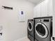 Laundry room with washer, dryer, and cabinets at 1626 Plover Cir, Fuquay Varina, NC 27526