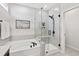 Spa-like bathroom with soaking tub, glass shower, and modern fixtures at 1626 Plover Cir, Fuquay Varina, NC 27526
