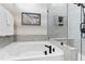 Bathroom featuring a soaking tub, glass shower, and modern fixtures at 1626 Plover Cir, Fuquay Varina, NC 27526