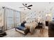 Spacious main bedroom with a comfortable bed, ceiling fan, and patterned wallpaper at 1626 Plover Cir, Fuquay Varina, NC 27526