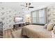 Relaxing main bedroom featuring a large bed, wall-mounted TV, and leafy wallpaper at 1626 Plover Cir, Fuquay Varina, NC 27526
