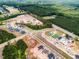 Aerial view of the community showcasing a pool, tennis courts, and new home construction at 1705 Clydner Dr, Cary, NC 27523