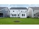 Well-maintained backyard with lush green lawn and a view of the home's exterior at 1705 Clydner Dr, Cary, NC 27523