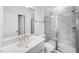 Well-lit bathroom featuring a modern vanity, a large mirror, and a glass-enclosed shower at 1705 Clydner Dr, Cary, NC 27523