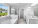Luxurious bathroom featuring a soaking tub, a separate glass-enclosed shower, and double vanity at 1705 Clydner Dr, Cary, NC 27523