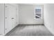 Well-lit bedroom with neutral carpeting, a double closet, and natural light from the window at 1705 Clydner Dr, Cary, NC 27523