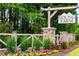 Community entrance sign 'Young Farm', set amidst colorful flowers, shrubs, and a decorative brick fence at 1705 Clydner Dr, Cary, NC 27523