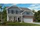 Two-story home with gray siding, brick accents, and a white porch at 1705 Clydner Dr, Cary, NC 27523