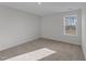 Sunny bedroom with carpet and a large window at 20 Windflower Ct, Clayton, NC 27520