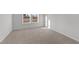 Well-lit bedroom with carpet and large window at 20 Windflower Ct, Clayton, NC 27520