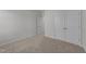 Spacious bedroom with neutral walls, carpet, and double door closet at 20 Windflower Ct, Clayton, NC 27520