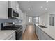 Modern kitchen with stainless steel appliances and white cabinetry at 20 Windflower Ct, Clayton, NC 27520