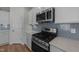 Stainless steel appliances and blue patterned backsplash in this kitchen at 20 Windflower Ct, Clayton, NC 27520